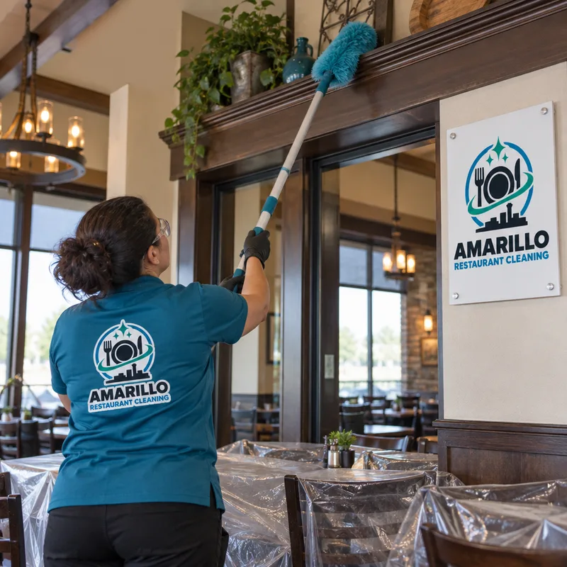 Cleaner high dusting dining room ledges and above-door trim with an extension tool while protecting tables and flooring